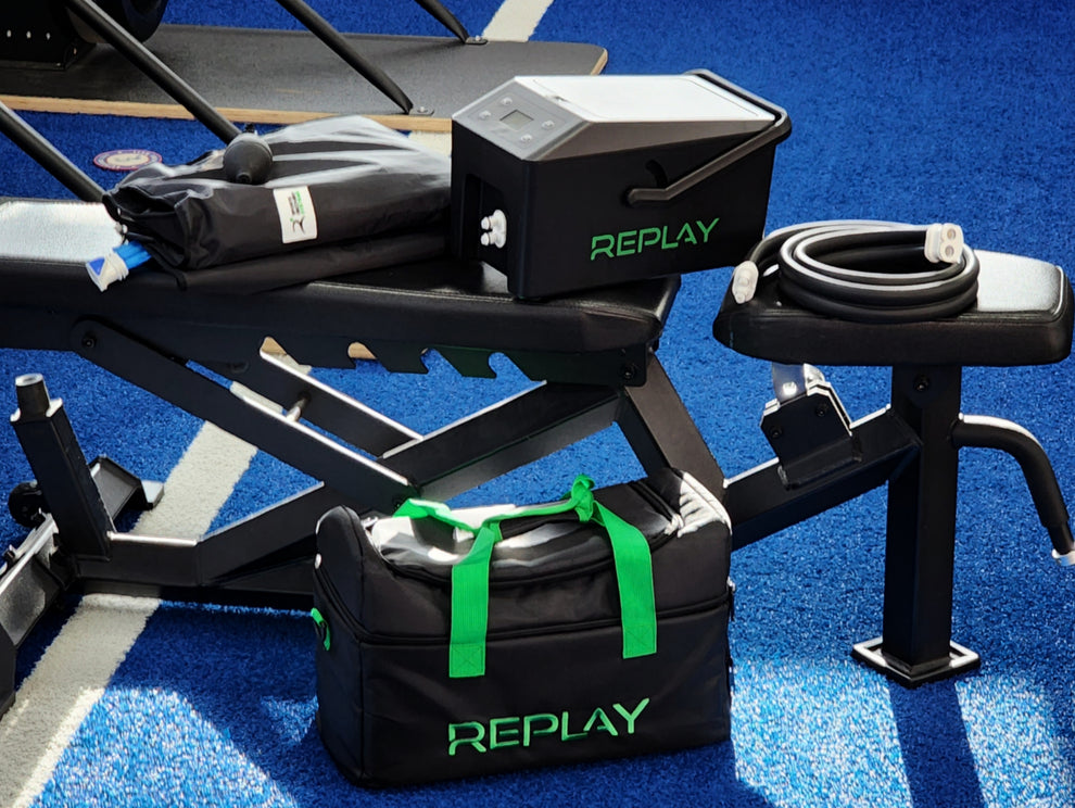 Polish_20230425_204315428 REPLAY compression therapy unit, hose, wrap and carry bag on gym benches